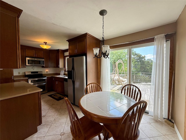 17 Wilson Rd, Brewster, NY 10509 - dining room with light tile patterned floors and a chandelier