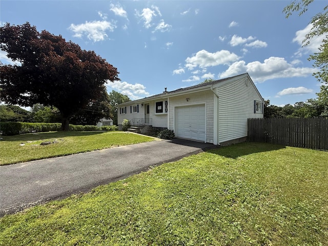 17 Wilson Rd, Brewster, NY 10509 - single story home with an attached garage and asphalt driveway