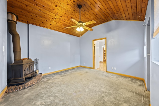 1400 Raleigh Rd, Mamaroneck, NY 10543 - empty room with vaulted ceiling, wooden ceiling, ceiling fan, carpet, and a wood stove