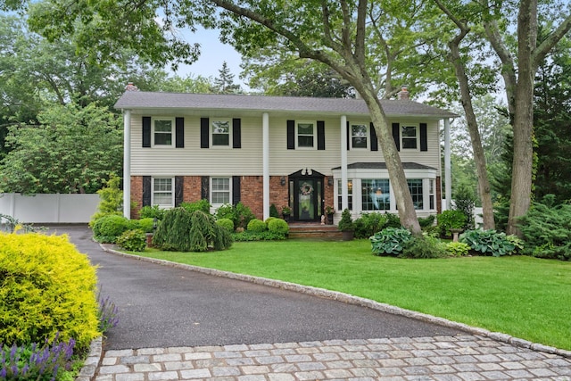 22 Arleigh Rd, East Northport, NY 11731 - colonial house with a chimney and brick siding