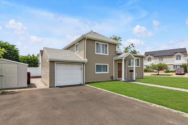 2716 Beach Dr, Merrick, NY 11566 - traditional-style home featuring an attached garage, a front lawn, and asphalt driveway