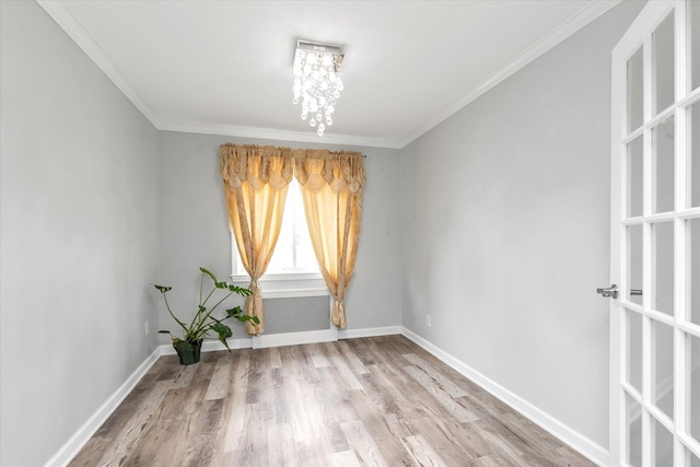 2716 Beach Dr, Merrick, NY 11566 - spare room featuring wood finished floors, a chandelier, baseboards, and ornamental molding
