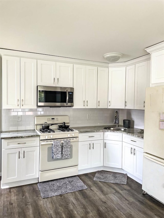 85 Ferndale Ave, Selden, NY 11784 - kitchen featuring white appliances, white cabinetry, backsplash, and dark wood finished floors