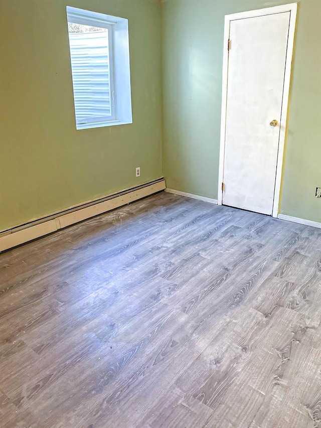 85 Ferndale Ave, Selden, NY 11784 - spare room with wood finished floors and baseboard heating