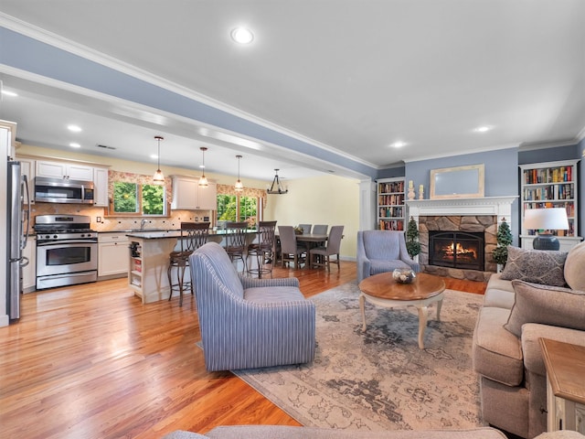 15 Tennyson Dr, Nanuet, NY 10954 - living area with ornamental molding, light wood-style floors, a fireplace, and baseboards