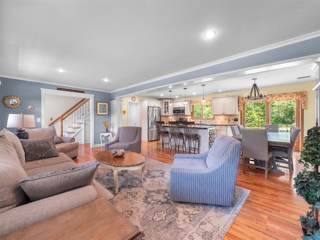15 Tennyson Dr, Nanuet, NY 10954 - living area with stairway, crown molding, light wood-style flooring, baseboards, and recessed lighting