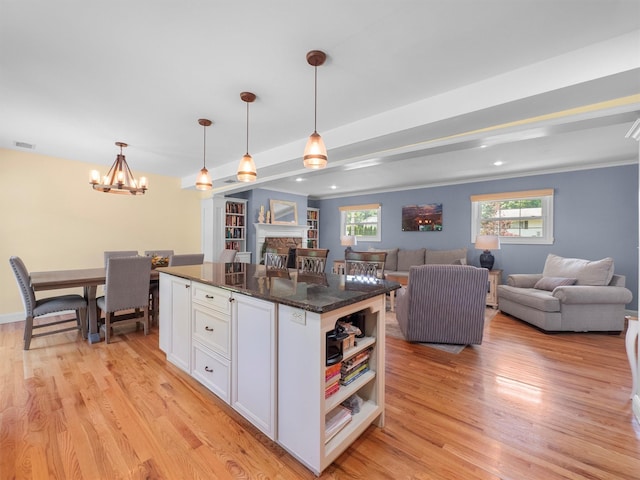 15 Tennyson Dr, Nanuet, NY 10954 - kitchen featuring white cabinets, light wood-style floors, a center island, a chandelier, and open shelves