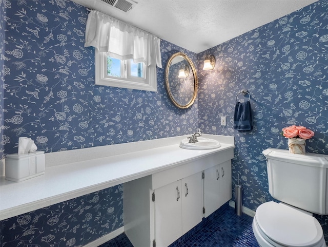 15 Tennyson Dr, Nanuet, NY 10954 - half bathroom featuring a textured ceiling, toilet, tile patterned flooring, vanity, and baseboards