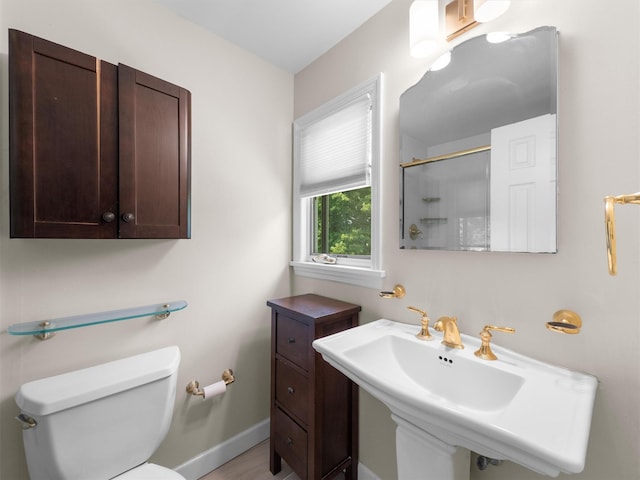 15 Tennyson Dr, Nanuet, NY 10954 - bathroom with toilet, an enclosed shower, a sink, and baseboards
