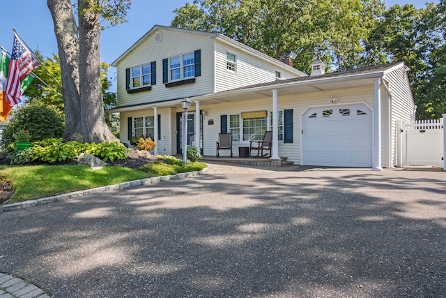 81 Brunswick Rd, Ronkonkoma, NY 11779 - view of front of property featuring covered porch, an attached garage, and asphalt driveway