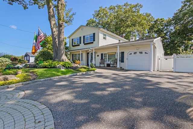 81 Brunswick Rd, Ronkonkoma, NY 11779 - view of front of house featuring an attached garage, covered porch, and driveway