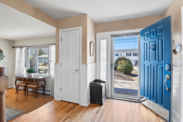 81 Brunswick Rd, Ronkonkoma, NY 11779 - entrance foyer with plenty of natural light, wood finished floors, and a baseboard radiator