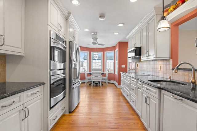 81 Brunswick Rd, Ronkonkoma, NY 11779 - kitchen with a sink, appliances with stainless steel finishes, light wood-style flooring, white cabinetry, and recessed lighting