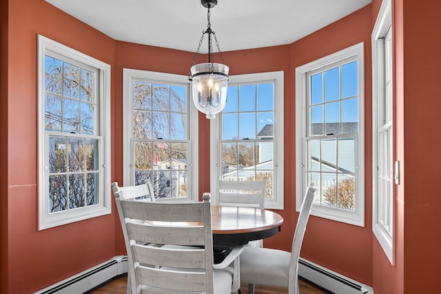 81 Brunswick Rd, Ronkonkoma, NY 11779 - dining area with baseboard heating and a chandelier
