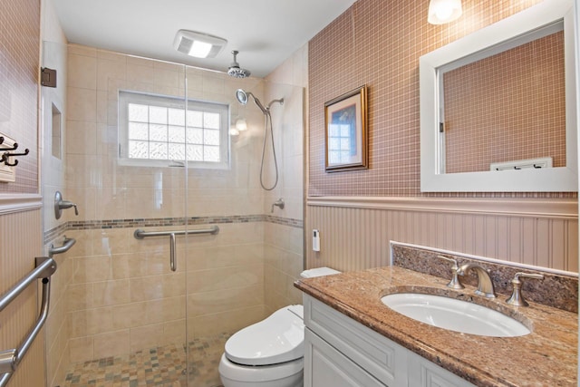 81 Brunswick Rd, Ronkonkoma, NY 11779 - bathroom featuring a shower stall, vanity, toilet, and wainscoting