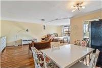 63-95 Austin St Unit 2F, Rego Park, NY 11374 - dining room with a chandelier and dark wood finished floors