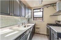 63-95 Austin St Unit 2F, Rego Park, NY 11374 - kitchen with stainless steel gas range oven, a sink, light countertops, and ventilation hood