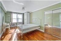 63-95 Austin St Unit 2F, Rego Park, NY 11374 - bedroom featuring wood finished floors, crown molding, and baseboards