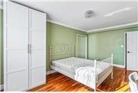 63-95 Austin St Unit 2F, Rego Park, NY 11374 - bedroom featuring dark wood-style flooring and crown molding