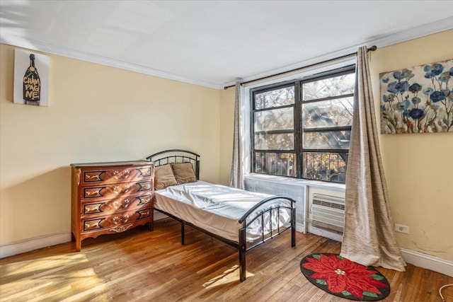 63-95 Austin St Unit 2F, Rego Park, NY 11374 - bedroom featuring wood finished floors, ornamental molding, and an AC wall unit