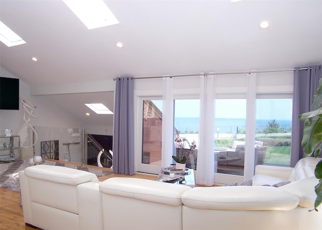 12 Sound View Dr, Rocky Point, NY 11778 - living room with a skylight, plenty of natural light, a water view, wood finished floors, and lofted ceiling