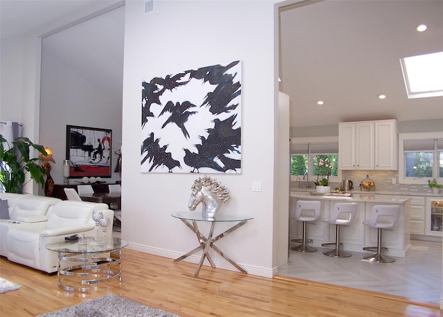 12 Sound View Dr, Rocky Point, NY 11778 - living room with a skylight, recessed lighting, and light wood-style floors