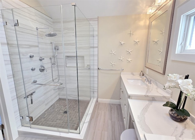 12 Sound View Dr, Rocky Point, NY 11778 - bathroom with a shower stall, vanity, wood finished floors, and vaulted ceiling