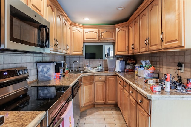 72 Parkway Blvd, Ronkonkoma, NY 11779 - kitchen with stainless steel appliances, decorative backsplash, light tile patterned floors, and light countertops