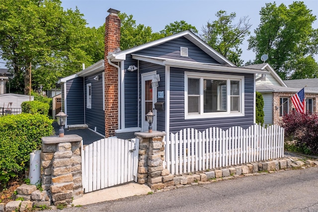 6 Beech Pl Unit 6, Bronx, NY 10465 - shotgun-style home with a fenced front yard, a chimney, and a gate