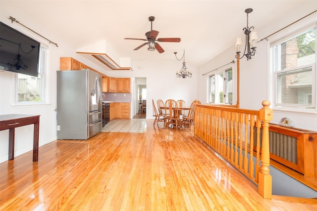 6 Beech Pl Unit 6, Bronx, NY 10465 - kitchen with stainless steel fridge with ice dispenser, light wood-style flooring, a ceiling fan, and a chandelier