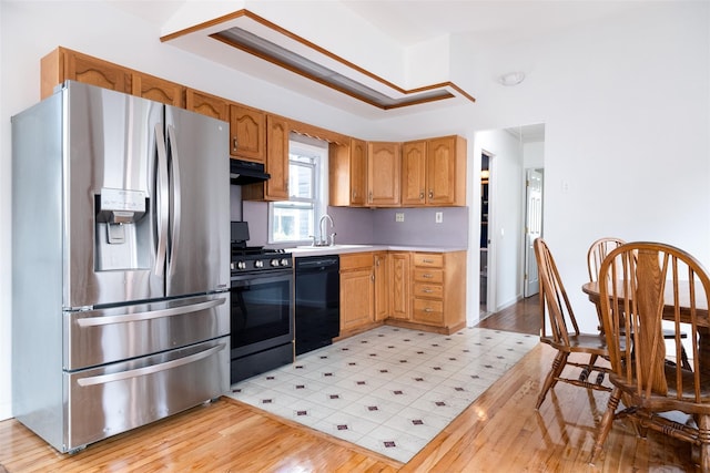 6 Beech Pl Unit 6, Bronx, NY 10465 - kitchen featuring stainless steel appliances, ventilation hood, a sink, light countertops, and light wood-type flooring