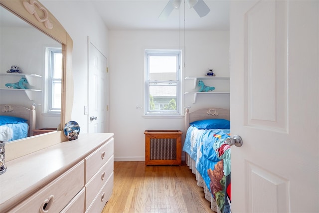 6 Beech Pl Unit 6, Bronx, NY 10465 - bedroom with light wood finished floors, radiator, a ceiling fan, and baseboards