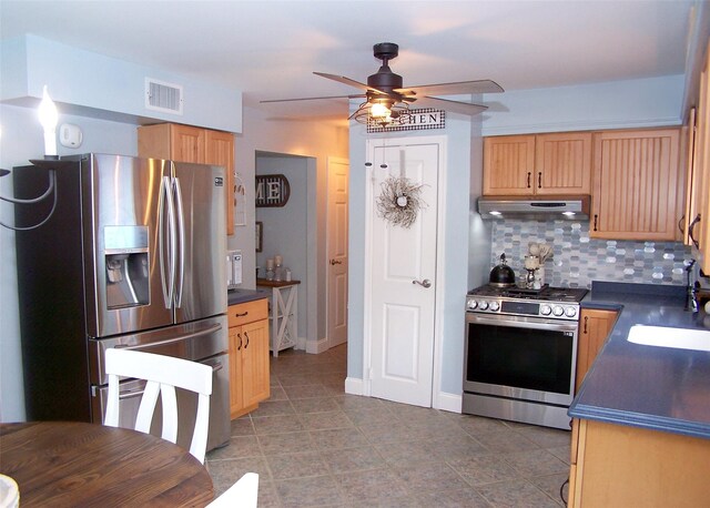 53 Admiral St, Port Jefferson Station, NY 11776 - kitchen featuring stainless steel appliances, under cabinet range hood, dark countertops, and a sink