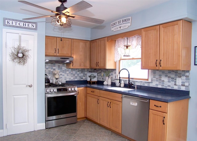53 Admiral St, Port Jefferson Station, NY 11776 - kitchen with stainless steel appliances, a sink, dark countertops, under cabinet range hood, and a ceiling fan