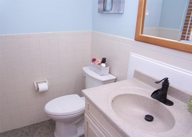 53 Admiral St, Port Jefferson Station, NY 11776 - half bath with toilet, vanity, tile walls, tile patterned floors, and a wainscoted wall