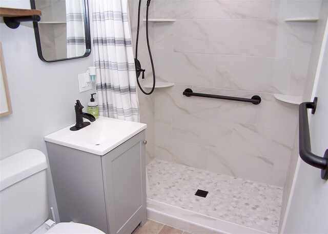 53 Admiral St, Port Jefferson Station, NY 11776 - bathroom with toilet, tiled shower, and vanity