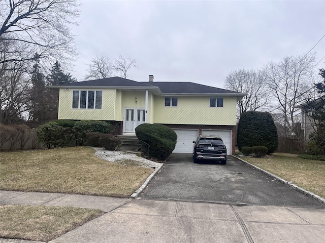 4 Farmstead Rd, Commack, NY 11725 - split foyer home with driveway, a garage, a chimney, and french doors