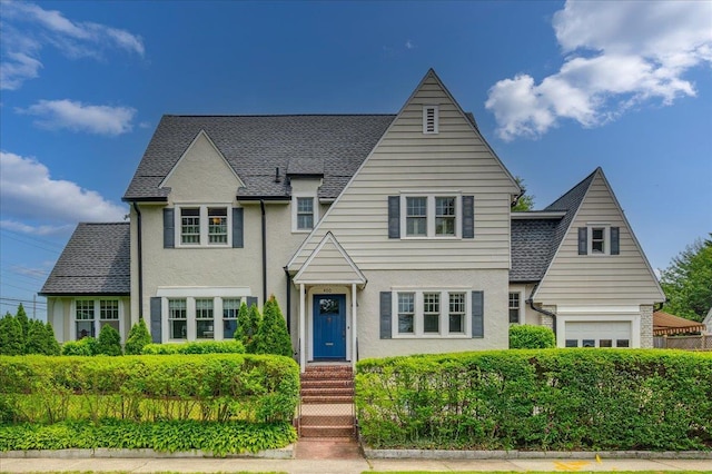 400 Manor Ridge Rd, Pelham, NY 10803 - view of front facade with stucco siding, a garage, and a shingled roof
