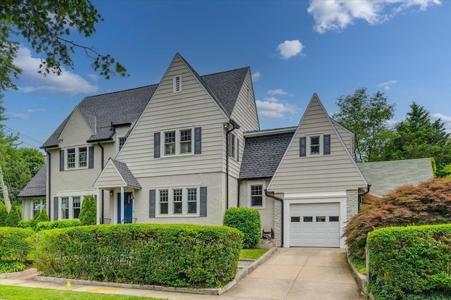 400 Manor Ridge Rd, Pelham, NY 10803 - view of front of home featuring concrete driveway, a shingled roof, and stucco siding