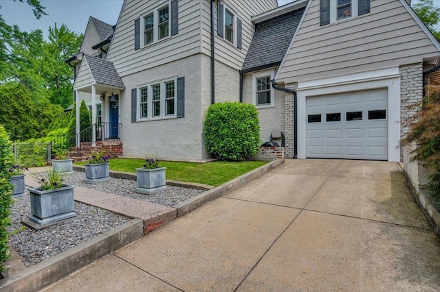 400 Manor Ridge Rd, Pelham, NY 10803 - view of front of house featuring concrete driveway, a garage, a shingled roof, and stucco siding