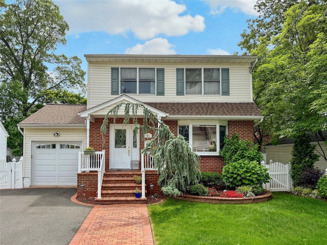 156 E Maujer St, Valley Stream, NY 11580 - view of front of home featuring an attached garage, a gate, asphalt driveway, and brick siding