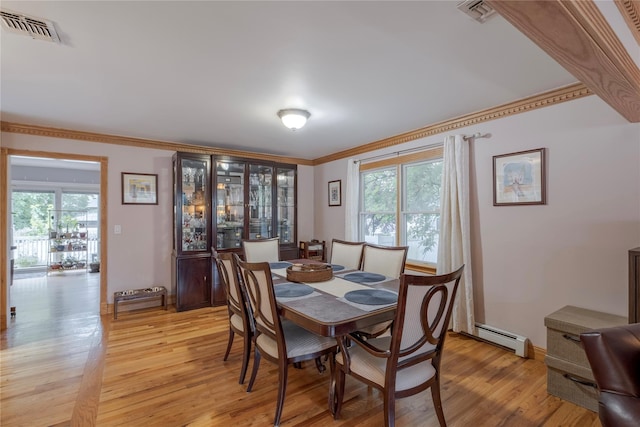 156 E Maujer St, Valley Stream, NY 11580 - dining room with baseboard heating, crown molding, plenty of natural light, and light wood finished floors