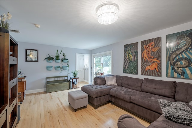 156 E Maujer St, Valley Stream, NY 11580 - living room with light wood-style flooring and a chandelier