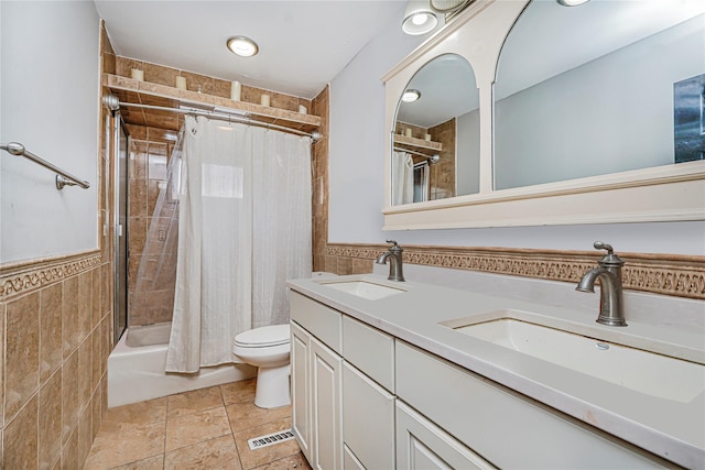 15 Oliver Pl, Staten Island, NY 10314 - bathroom featuring double vanity, shower / bath combination with curtain, toilet, tile walls, and wainscoting