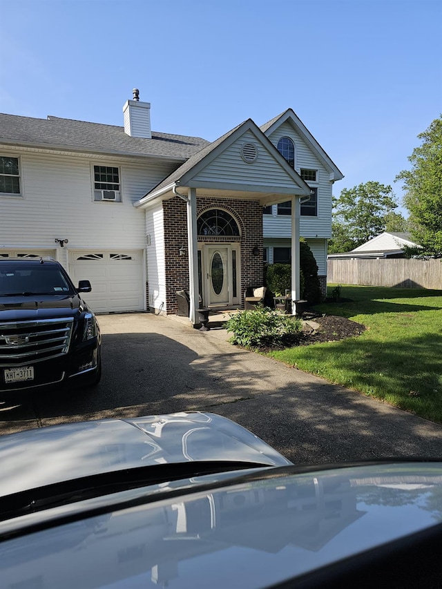 943 Macarthur St, Bohemia, NY 11716 - view of front of property featuring brick siding, asphalt driveway, and a chimney