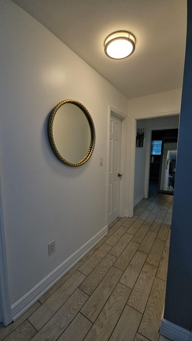 943 Macarthur St, Bohemia, NY 11716 - corridor featuring light wood finished floors and baseboards