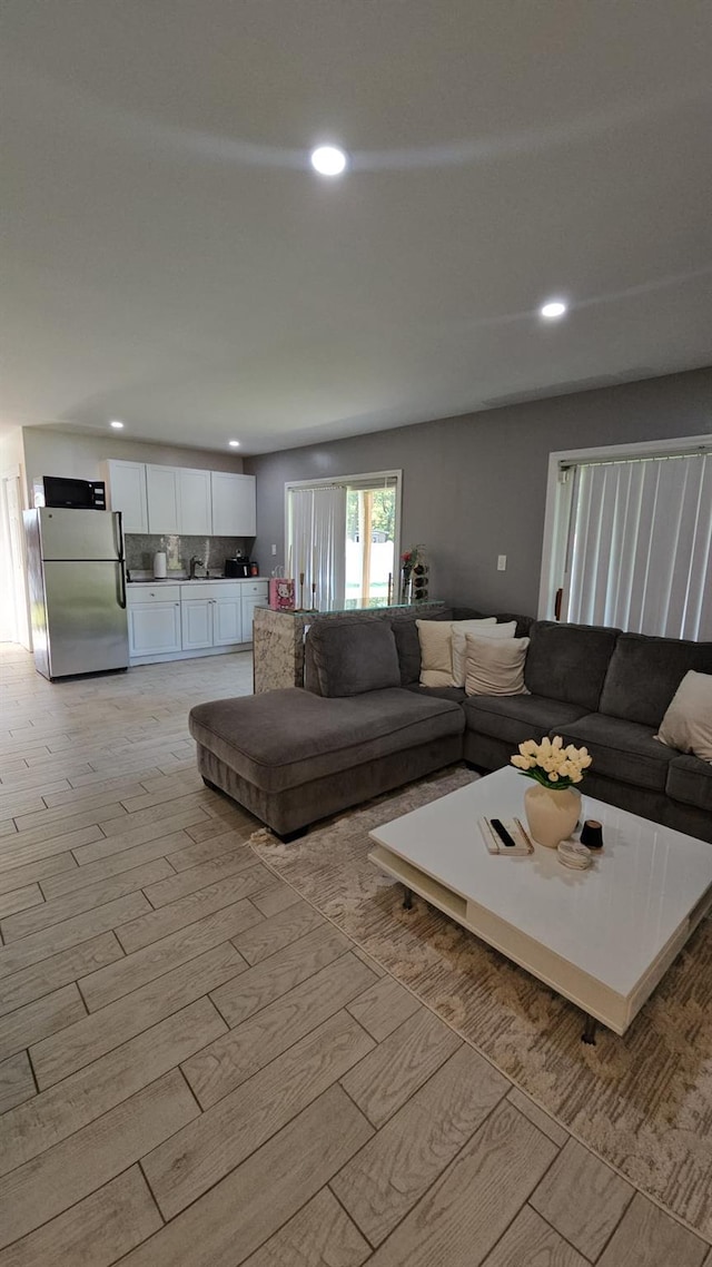 943 Macarthur St, Bohemia, NY 11716 - living area with recessed lighting and light wood-type flooring