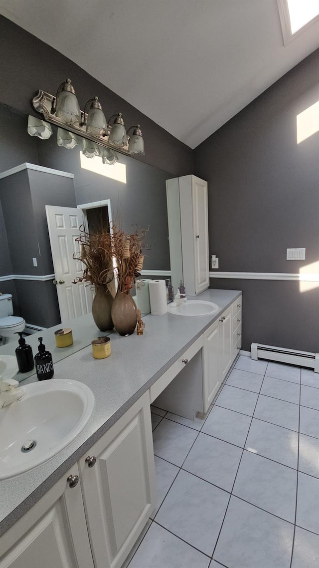 943 Macarthur St, Bohemia, NY 11716 - bathroom with double vanity, baseboard heating, and tile patterned floors