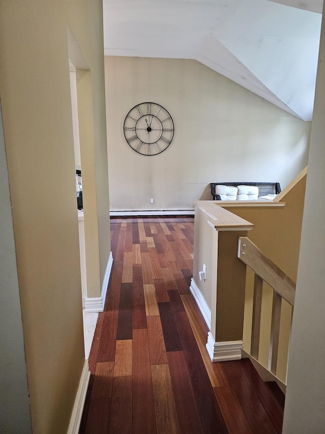 943 Macarthur St, Bohemia, NY 11716 - hallway with wood finished floors, vaulted ceiling, a baseboard radiator, and an upstairs landing