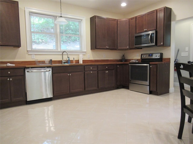 101 Bundy Hill Rd, Holmes, NY 12531 - kitchen with stainless steel appliances, dark countertops, dark brown cabinets, recessed lighting, and hanging light fixtures